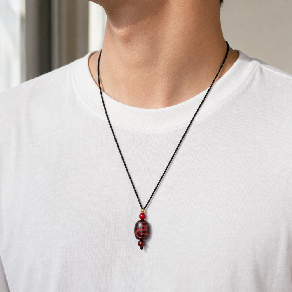 Male model wearing red Dzi pendant necklace