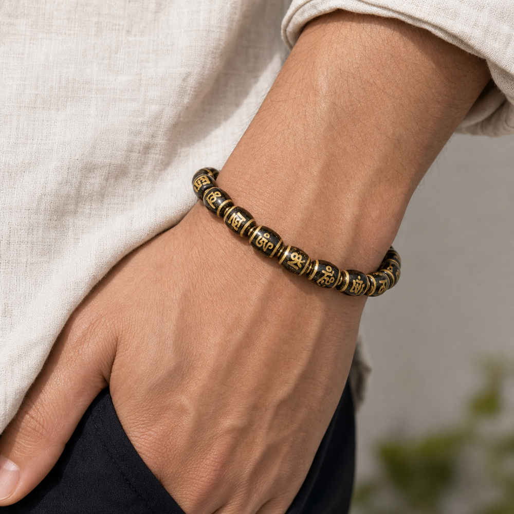 Male model wearing black and gold Dzi bracelet