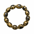 Black and gold Tibetan Dzi bracelet on white background