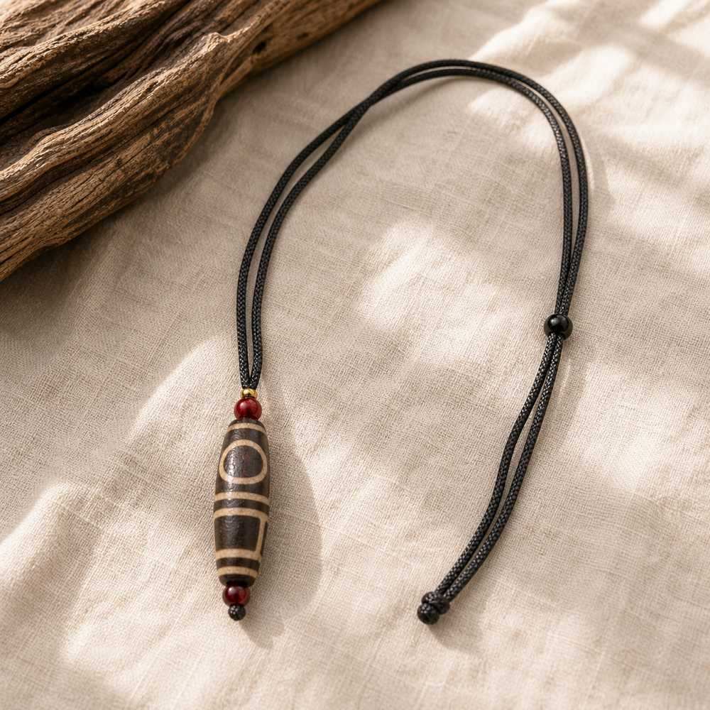 Single-eye Dzi pendant lifestyle scene