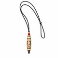 Light brown multi-eye Dzi pendant on white background