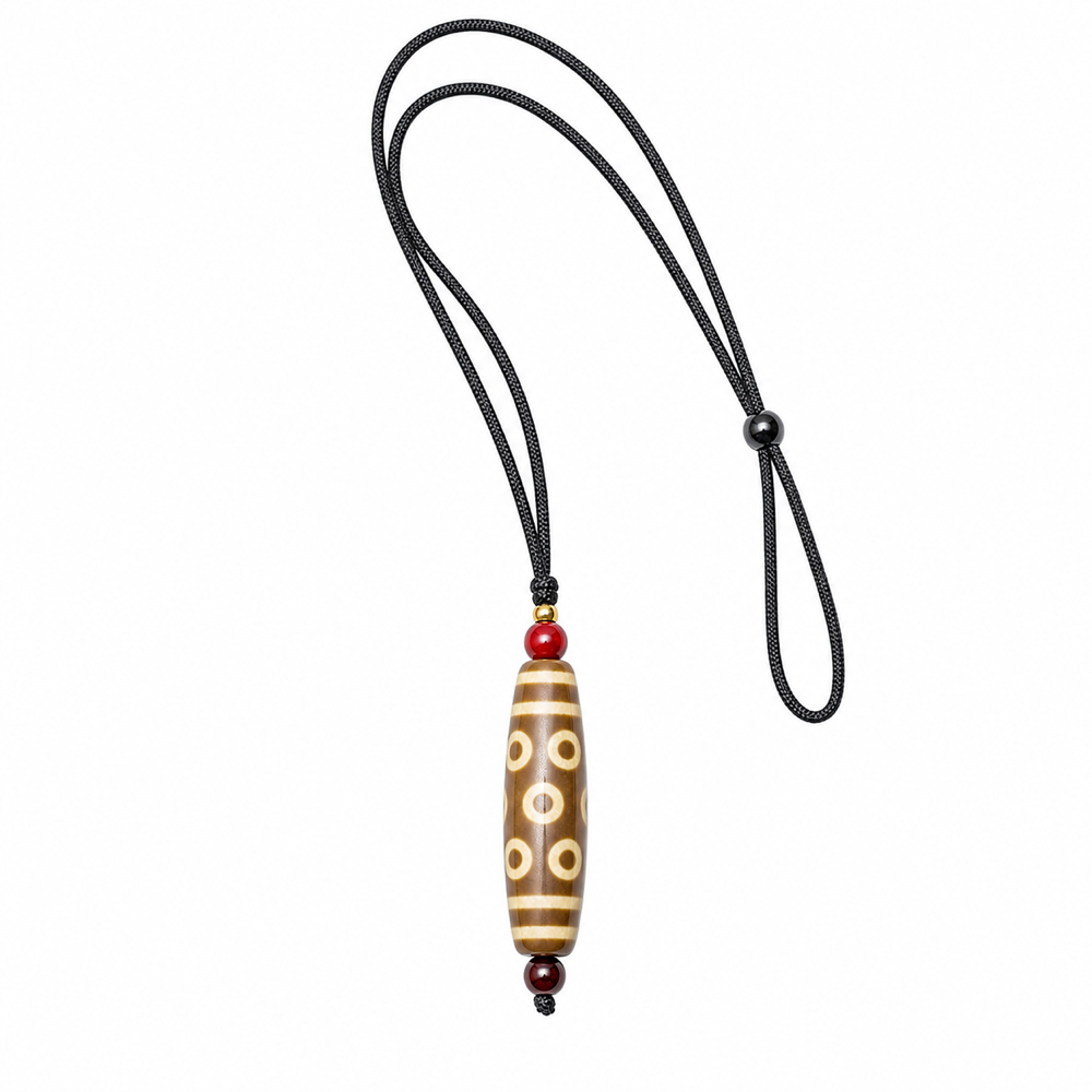Light brown multi-eye Dzi pendant on white background